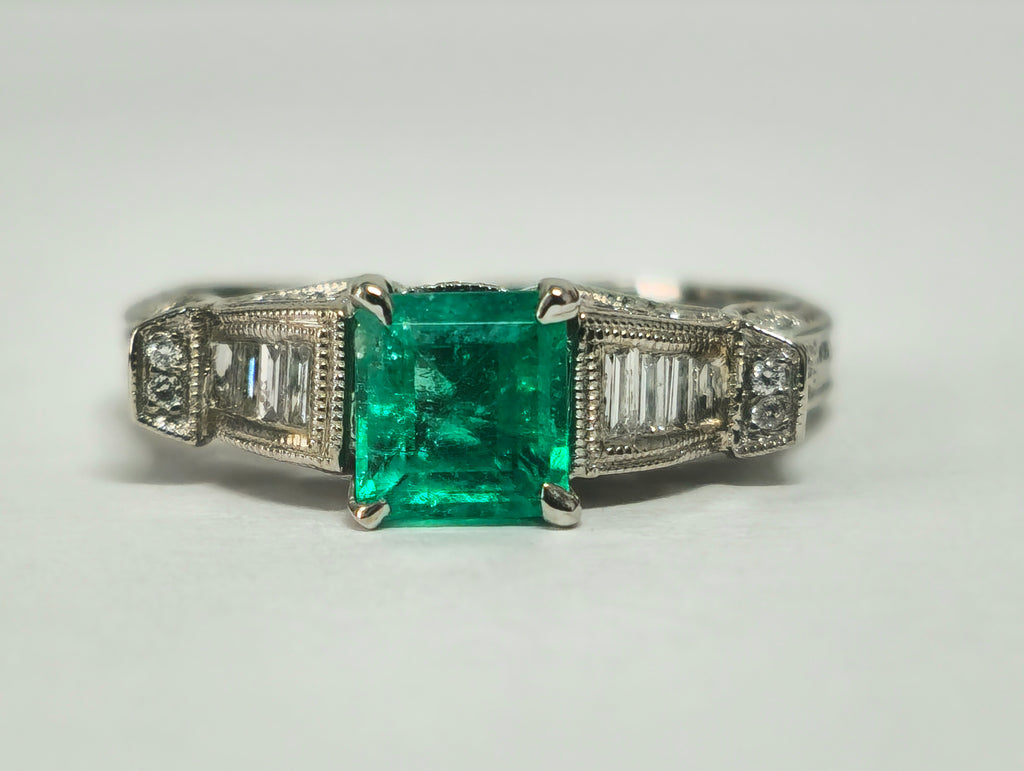Elegant Colombian emerald and diamond cocktail ring by Prince The Jeweler featuring a 1.50 carat center stone and intricate design.