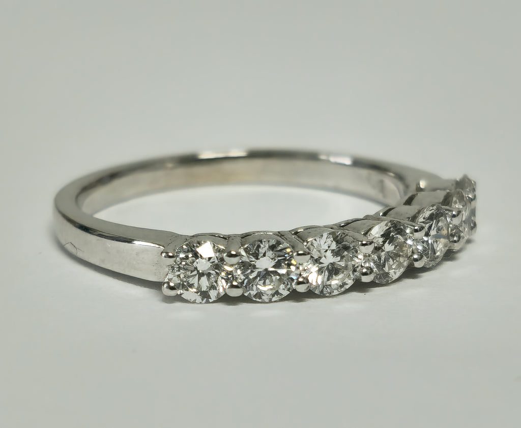 18k gold VVS diamond engagement ring for her, featuring a sparkling central diamond and intricate band design.