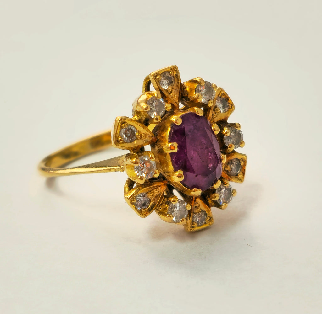 Antique ruby and diamond ring in 18k yellow gold, featuring intricate detailing and elegant gemstone setting.
