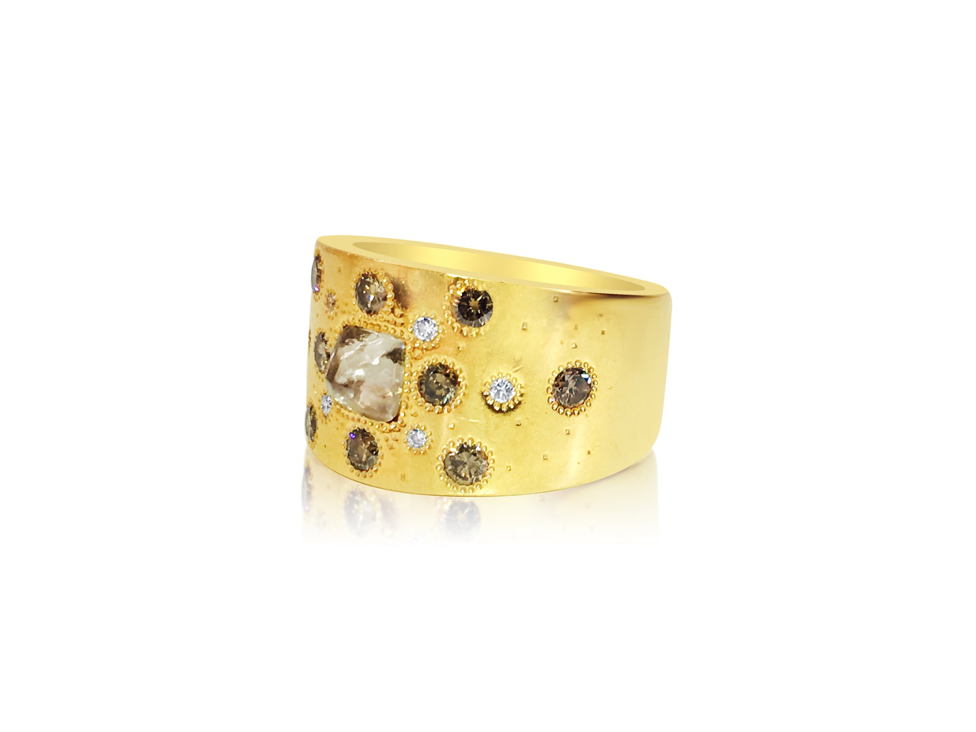 18K yellow gold ring with rough diamond, designed by De Beers, featuring a textured band and natural gemstone setting.