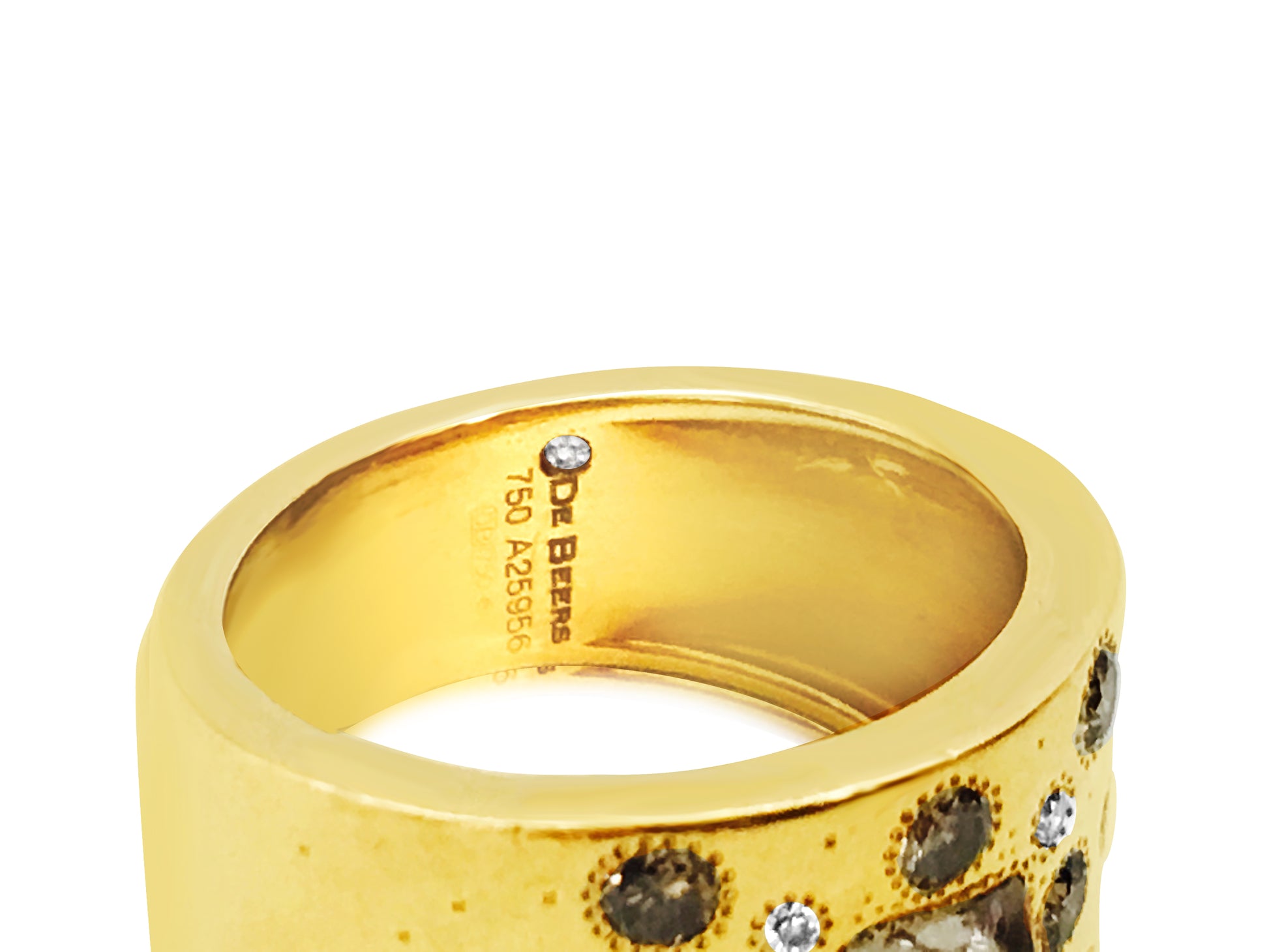 18K yellow gold and rough diamond ring by De Beers, featuring a textured band and raw diamond centerpiece.