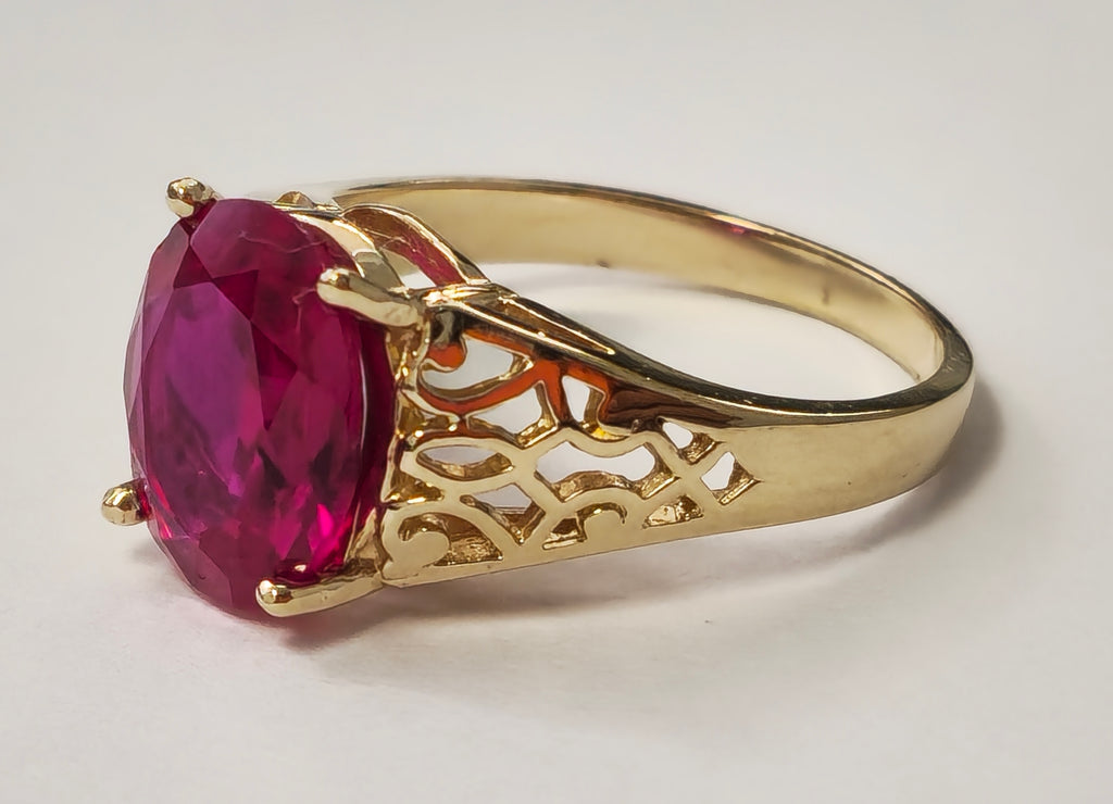 Vintage AAA Ruby Ring in yellow gold, featuring a large central ruby gemstone and intricate gold detailing, by Prince The Jeweler.
