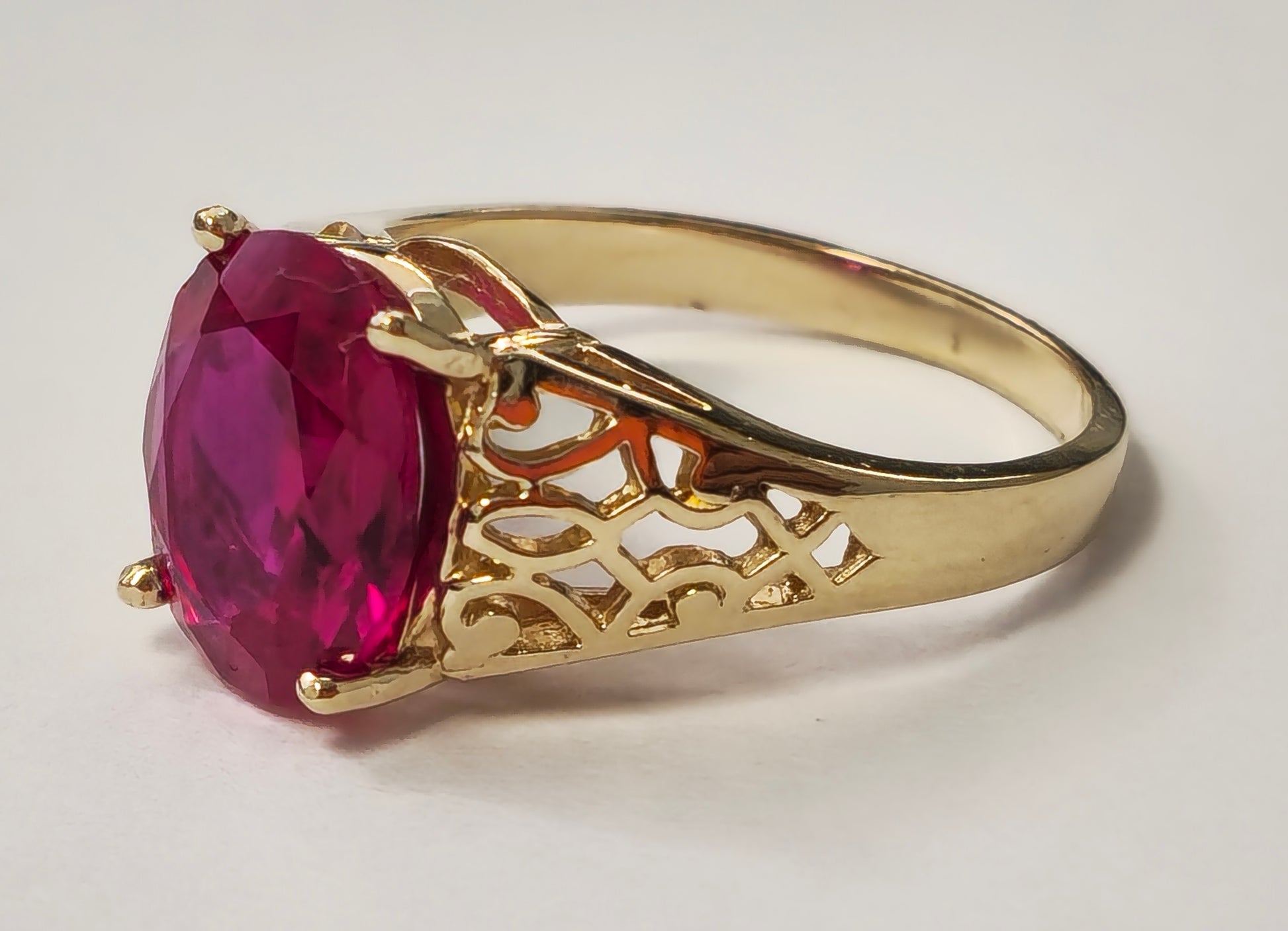 Vintage AAA Ruby Ring in yellow gold, featuring a large central ruby gemstone and intricate gold detailing, by Prince The Jeweler.