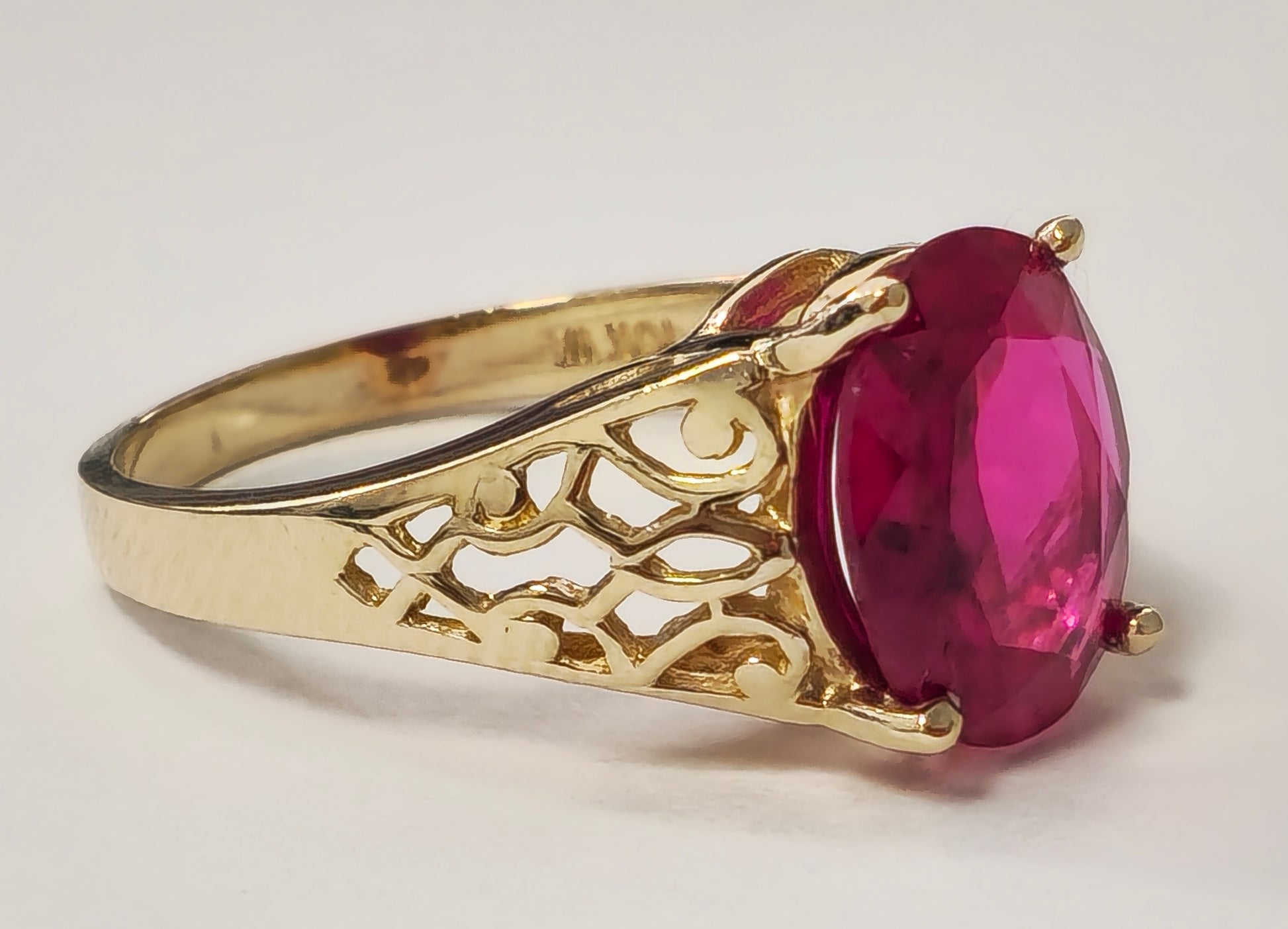 Vintage AAA ruby ring in yellow gold from Prince The Jeweler, showcasing a detailed design with a prominent ruby gemstone.