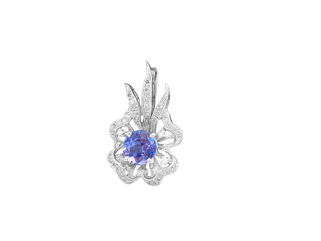 14k gold vintage diamond tanzanite pin featuring intricate design, sparkling diamonds, and a vibrant tanzanite gemstone.