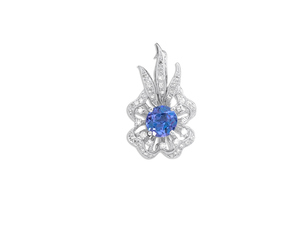 Vintage 14k gold diamond and tanzanite pin, elegant jewelry piece with intricate design and sparkling gemstones.