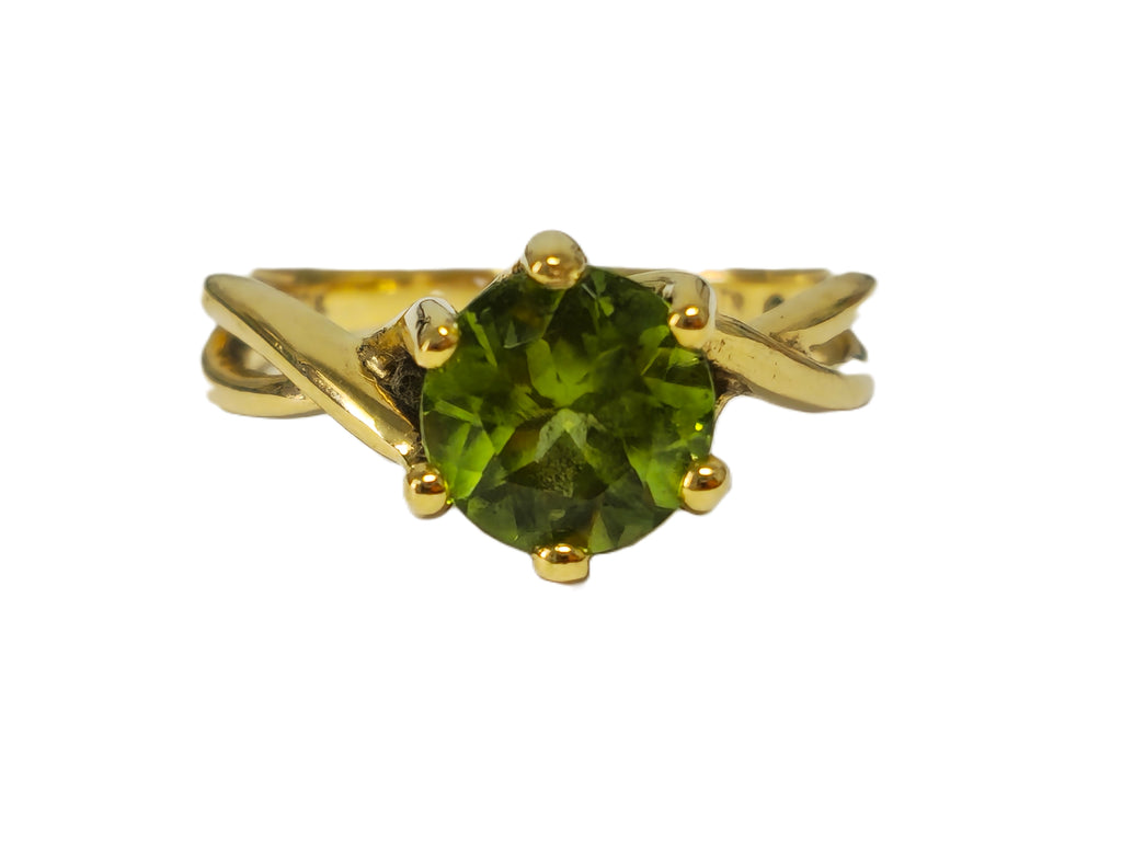 2.25ct garnet solitaire engagement ring by Prince The Jeweler featuring a round garnet gemstone set in a sleek band.
