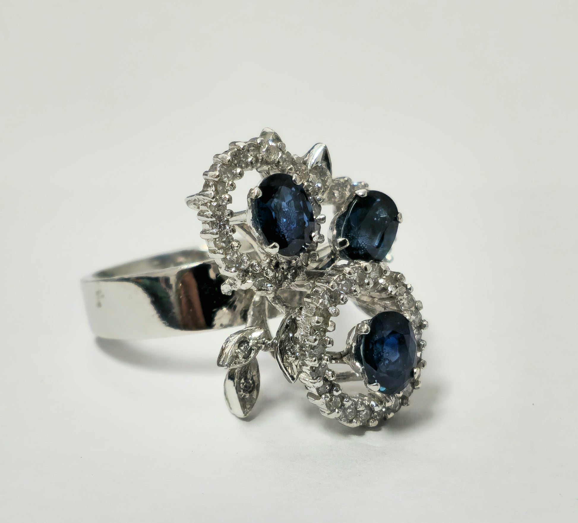 Natural 1.25ct sapphire and diamond ring featuring a gold band from Prince The Jeweler, shown on a jewelry display.