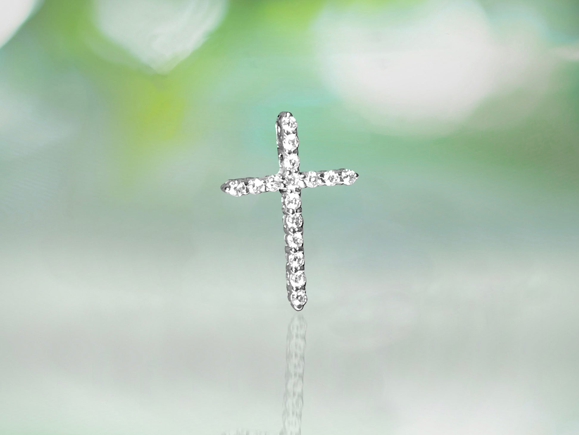 Unisex 14K white gold and diamond religious cross pendant with intricate design, crafted by Prince The Jeweler.