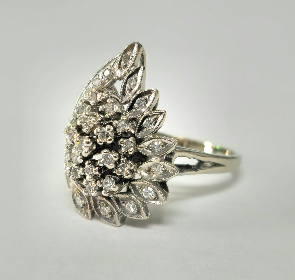 14k white gold engagement ring with wing motif and diamond accents, designed by Prince The Jeweler from the late 20th century.