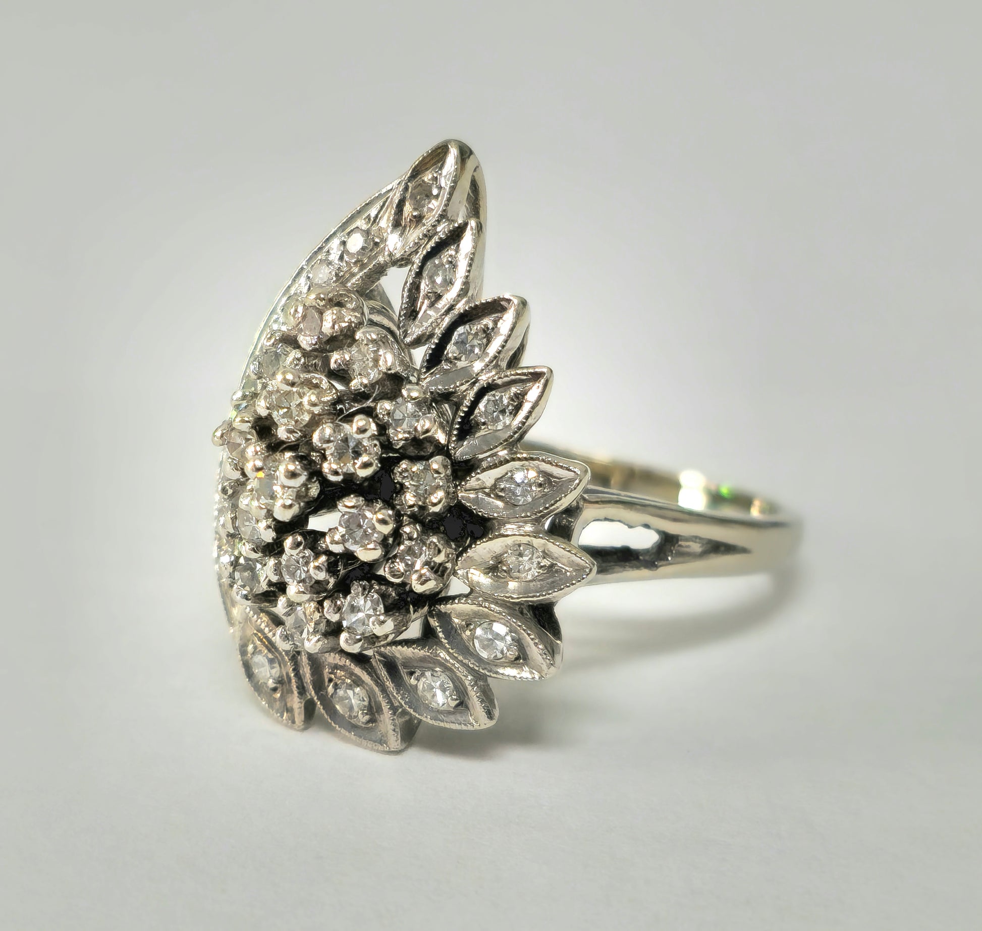 14k white gold engagement ring with wing motif and diamond accents, designed by Prince The Jeweler from the late 20th century.