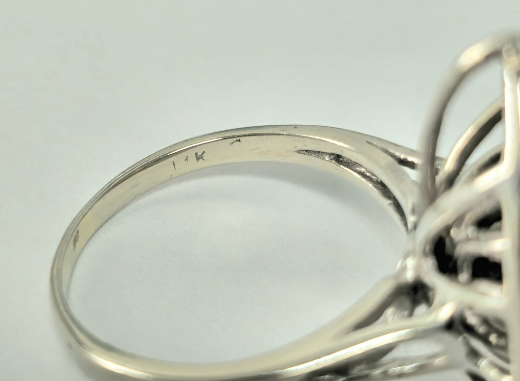Late 20th century wing motif 14k white gold diamond engagement ring with intricate design and sparkling diamonds.
