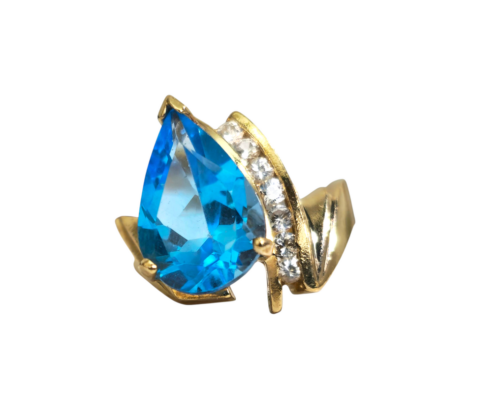 10k gold ring featuring a 5.80 carat blue topaz gemstone surrounded by diamonds, elegant jewelry piece by Prince The Jeweler