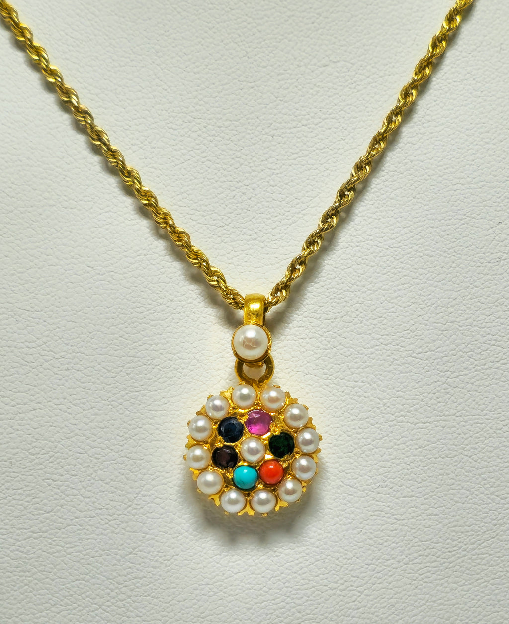 Vintage Mughal Empire style 22k yellow gold multigemstone pendant featuring intricate craftsmanship and vibrant gemstone accents.