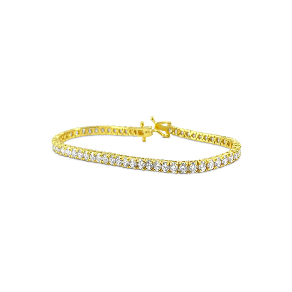 VVS diamond tennis bracelet with 6.25 carats set in 14k gold, featuring sparkling diamond accents on a sleek jewelry piece.