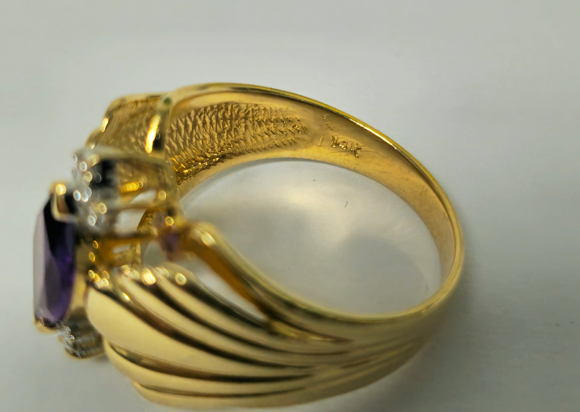 Victorian style 2.30 carat amethyst and diamond cocktail ring in 14k gold with intricate detailing.